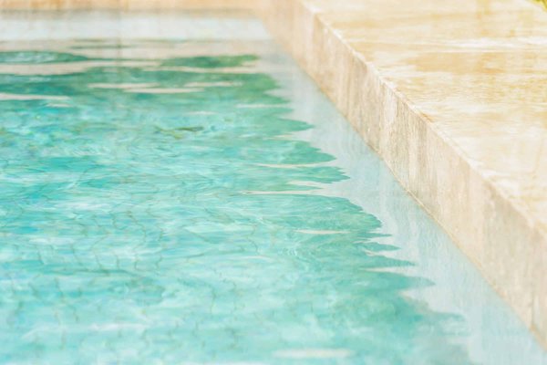 What are the critical safety measures for pools with automatic covers in UK homes?